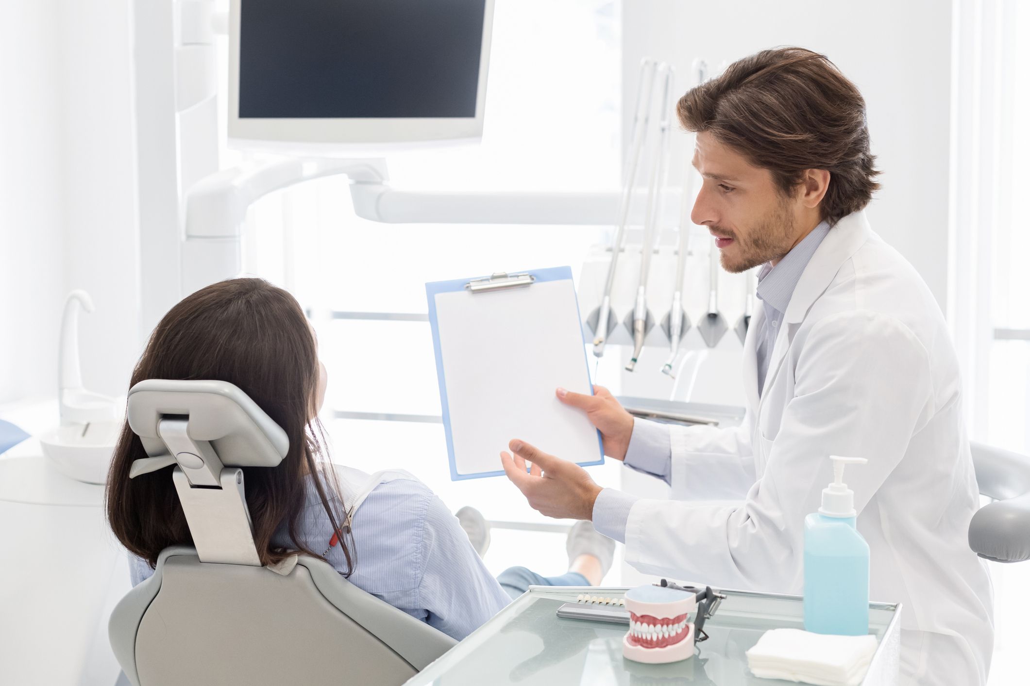 Dentist showing patient a sheet of paper