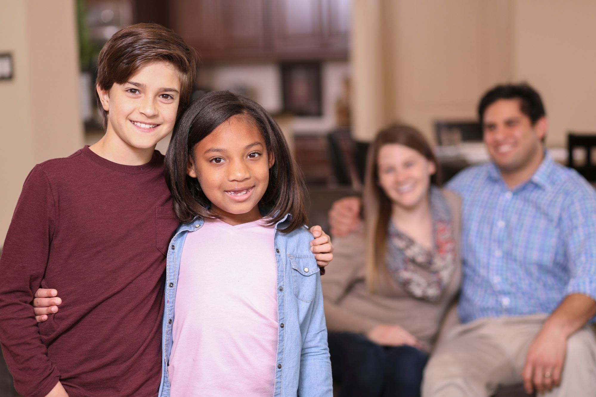 Foster kids standing in front of foster parents