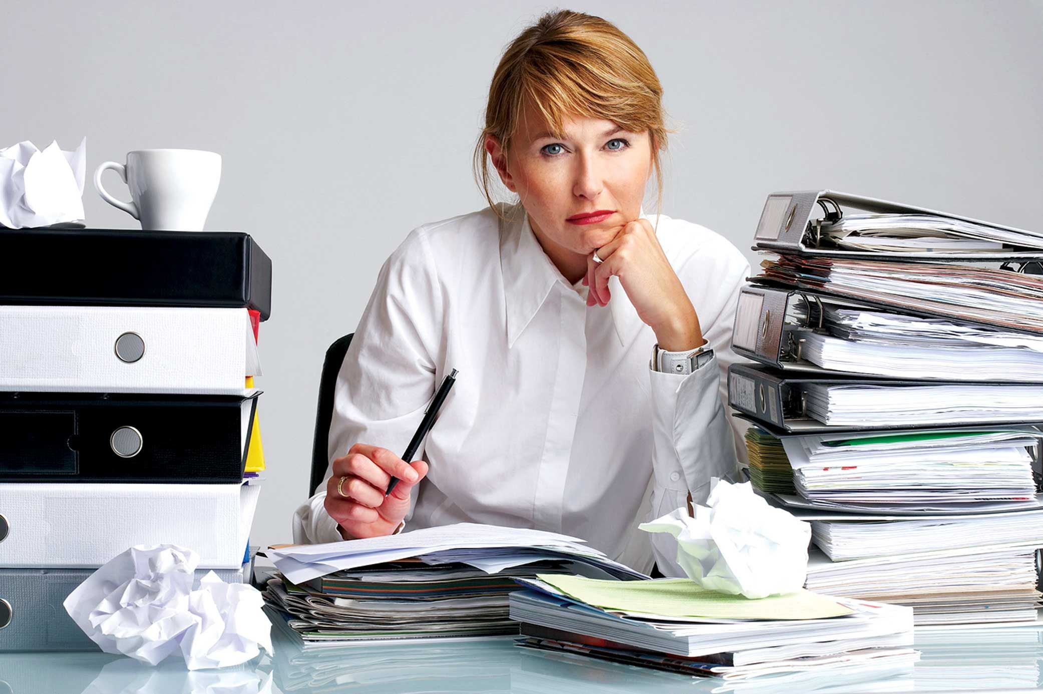 Woman sitting behind desk full of records