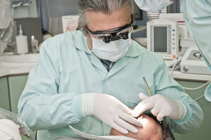 Dentist doing dental work in PPE