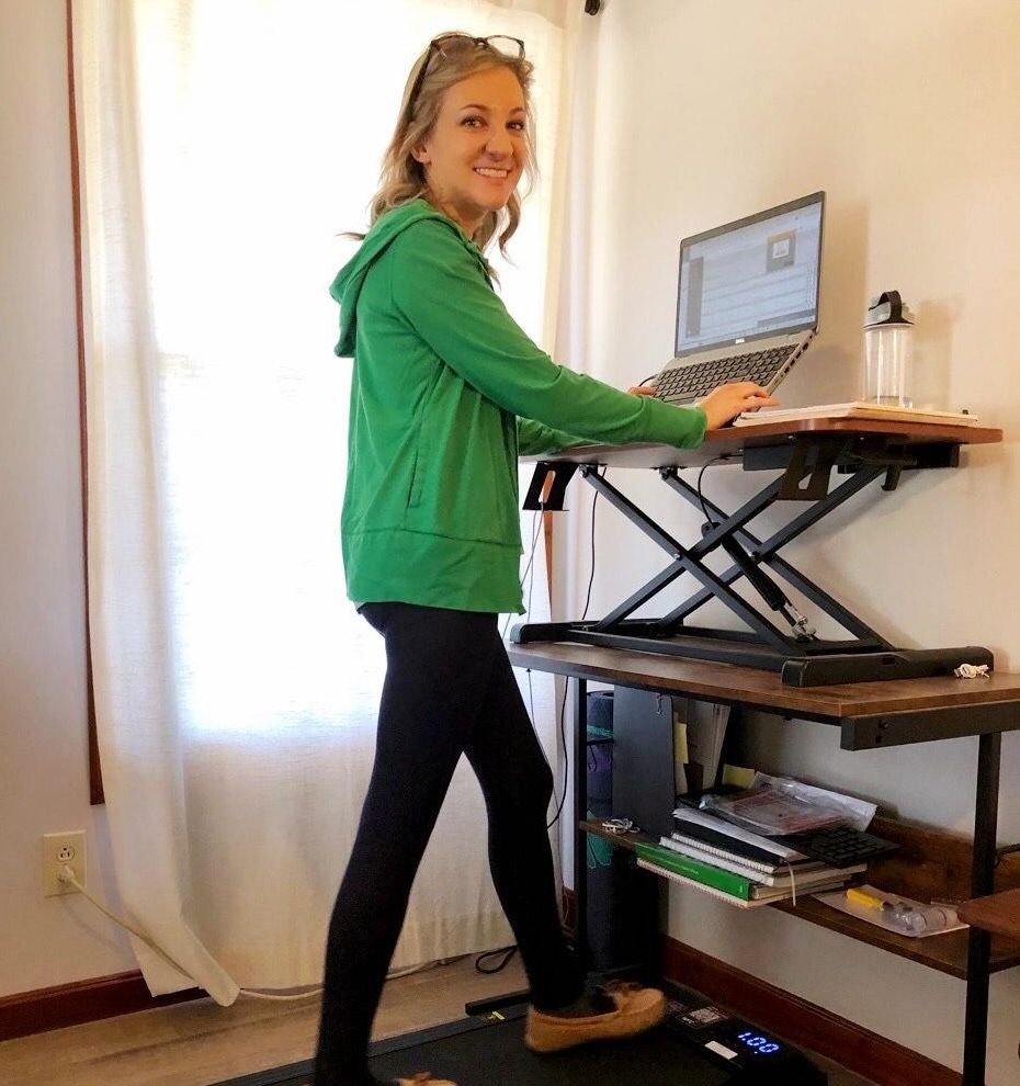 Walking on treadmill while working on laptop.