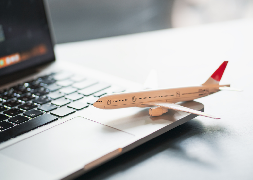 Model airplane sitting on laptop