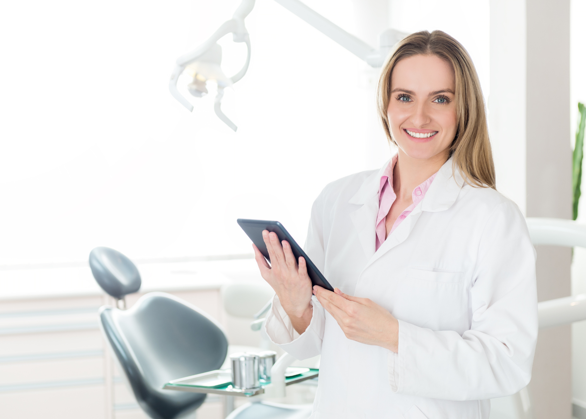 Dentist holding a clipboard, representing healthcare compliance and training resources in the shop.